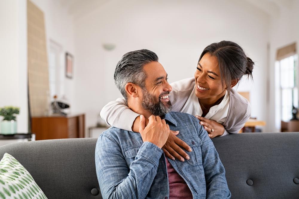 man and wife smiling.